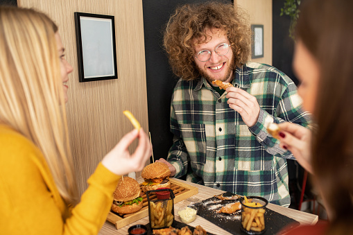 Three friends enjoying their time together in fast food restaurant