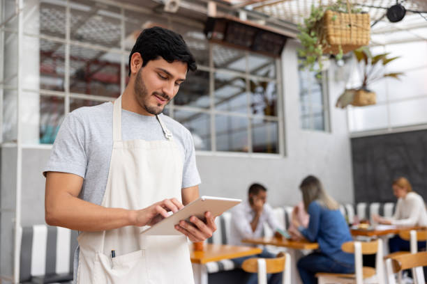 istock Portrait of a waiter working at a restaurant using a tablet 1372628008