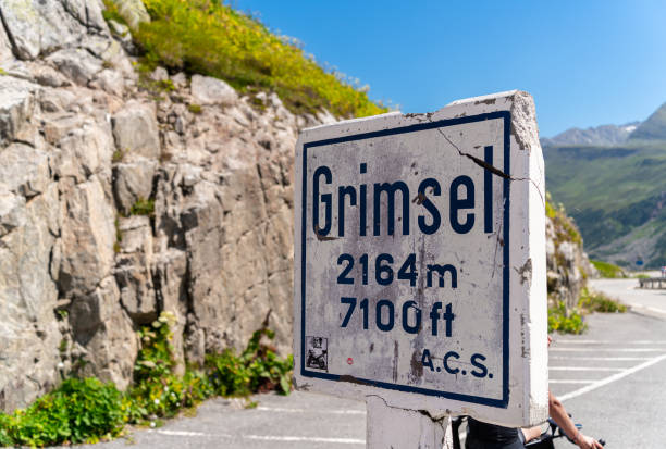 Sign of Grimsel mountain pass in Switzerland Grimselpass, Switzerland - August 13, 2021: The signpost at Grimsel Pass, a mountain pass in Switzerland, crossing the Bernese Alps at an elevation of 2164 metres. grimsel pass photos stock pictures, royalty-free photos & images