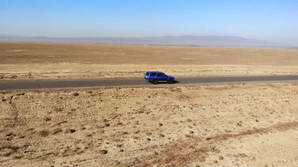 View of the empty road and mountains. Huge open desert landscape with dirt roads. dirt road in the steppe View of the empty road and mountains. Huge open desert landscape with dirt roads. dirt road in the steppe Haval H9 SUV stock pictures, royalty-free photos & images