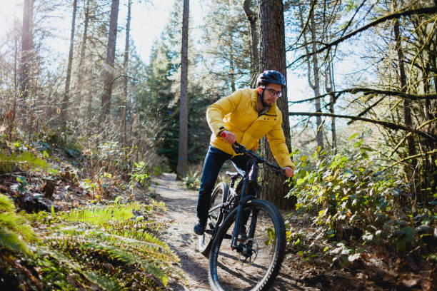 istock Young Man Mountain Biking in Forest 1372631262