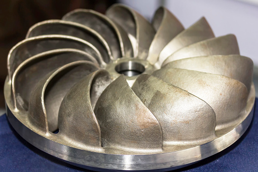 Close up impeller component of pump made from sand casting manufacturing process for industrial
