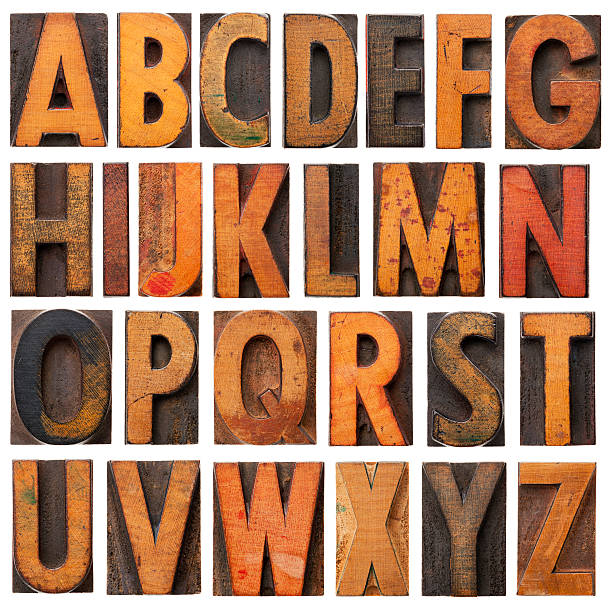 Vintage wooden alphabet blocks complete English alphabet - a collage of 26 isolated vintage wood letterpress printing blocks, scratched and stained by ink patina typescript photos stock pictures, royalty-free photos & images