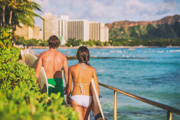 style de vie de surf sur la plage d’hawaï. jeunes surfeurs marchant avec des planches de surf sur la plage de waikiki touristes en vacances d’été. - outdoors waikiki waikiki beach honolulu photos et images de collection