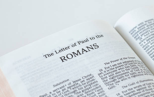 istock Romans open Holy Bible Book isolated on white background 1372636406