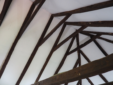 Fachwerk, a frame construction typical of the peasant architecture of many countries of Europe. Prussian wall. The roof truss system of the house. Ceiling beams, rafters and gratings