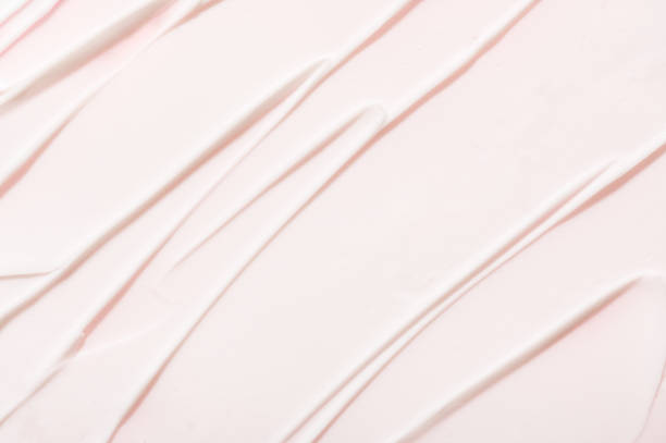 Smears pattern of anti allergic lotion on pink background