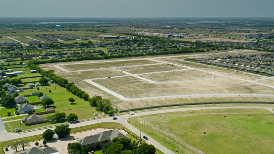 Aerial shot of tract housing under construction at the far edge of Fort Worth, Texas encroaching onto farmland.