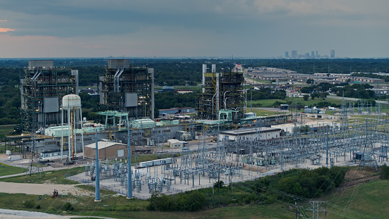 Aerial shot of a natural gas fueled power plant in Fort Worth, Texas on the shore of Lake Arlington at dusk.