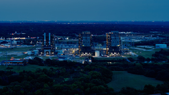Aerial shot of a natural gas fueled power plant in Fort Worth, Texas on the shore of Lake Arlington at night.