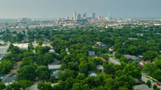 Aerial View of Downtown Fort Worth from Over Residential Neighborhood Aerial shot of of suburban streets in Fort Worth, Texas on a sunny day in summer, with the downtown skyline in the distance. fort worth stock pictures, royalty-free photos & images