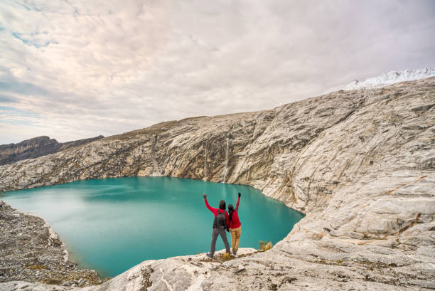 ワスカラン国立公園のアワックラグーンを見�るのを楽しんでいるカップル - huaraz ストックフォトと画像