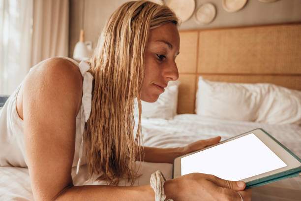 istock Young woman using a digital tablet from her comfortable bed- Morning 1372640612