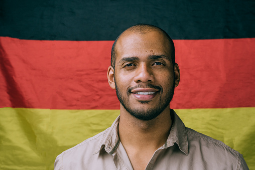 Black man with German flag in the background