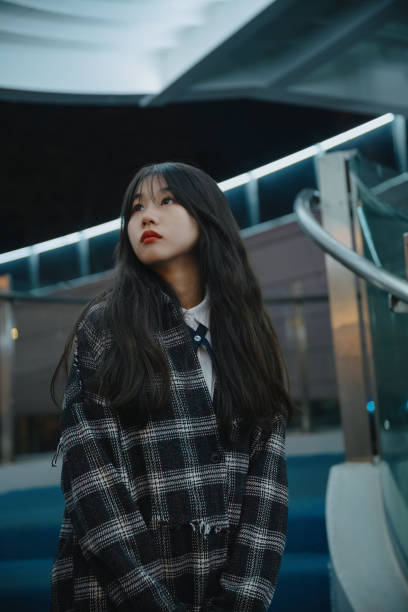 istock Asian young women on the bridge at night 1372641731