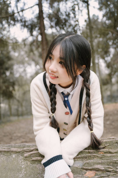 istock Asian pretty girl leaning against the tree 1372641852