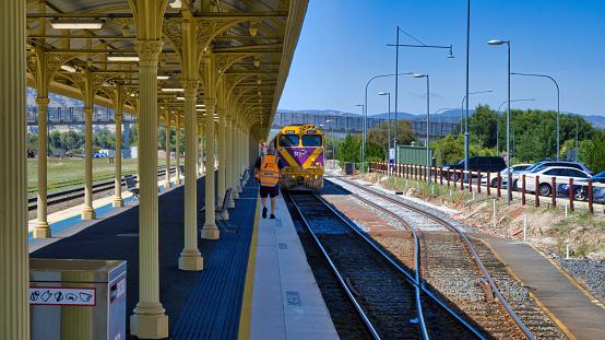 Albury, New South Wales Australia - December 23 2021: A Vline train crew member approaches a train at Albury Railway Station