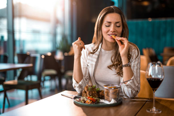 istock Happy woman eating lunch at a restaurant. 1372644022