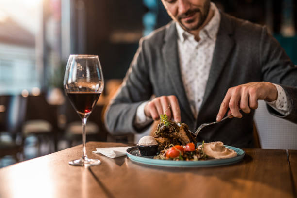 istock Happy young man eating lunch at a restaurant. 1372644764