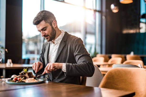 istock Happy man eating lunch at a restaurant. 1372645459