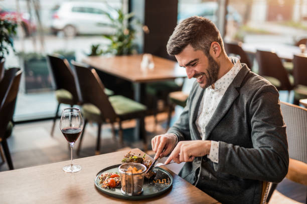 istock Happy man eating lunch at a restaurant. 1372645469