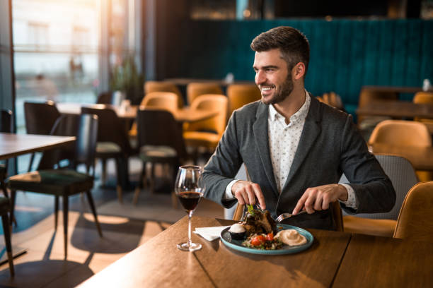 istock Happy man eating lunch at a restaurant. 1372645488