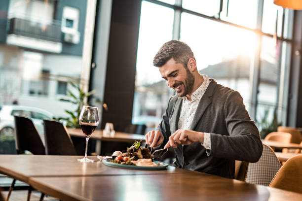 istock Happy man eating lunch at a restaurant. 1372645525
