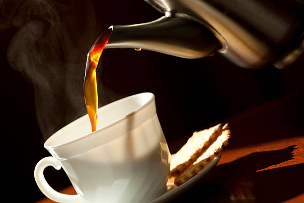 istock Pouring coffee into the white cup . Close-up. 137265109