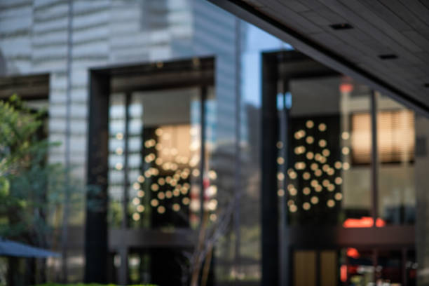 The outdoor plaza area of financial buildings in downtown Los Angeles showing  the reflection of lights in the exterior windows.