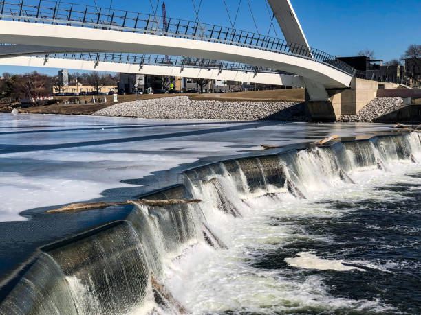 istock White single arch pedestrian bridge with waterfalls 1372662460