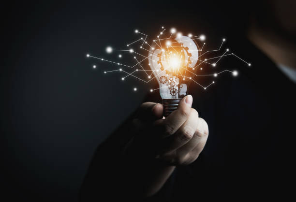 istock Businessman holding light bulb 1372663376