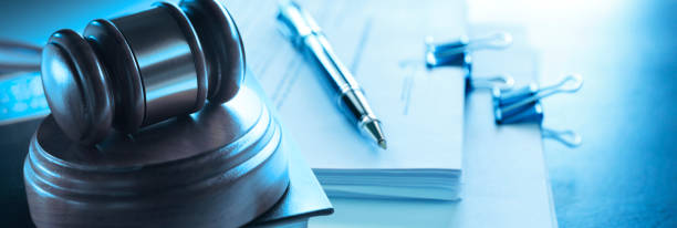 Gavel Resting On Top Of Law Book And Documents A gavel sits on its sounding block which rests on top of a law book and a stack of legal documents. Photographed with a very shallow depth of field. legal document stock pictures, royalty-free photos & images