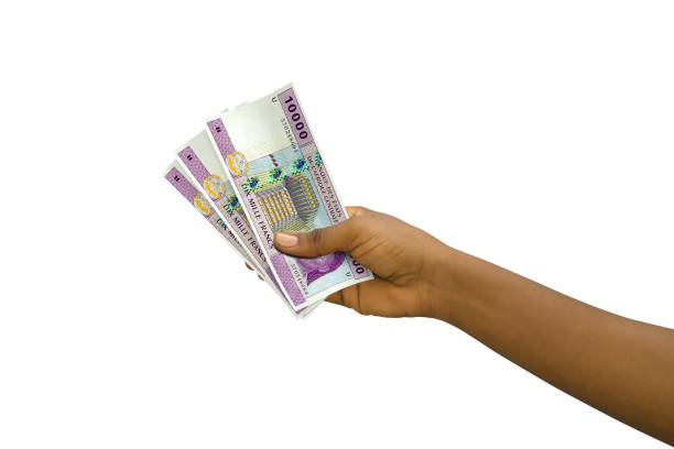 istock Fair hand holding 3D rendered 10000 Central African CFA franc notes isolated on white background 1372665418