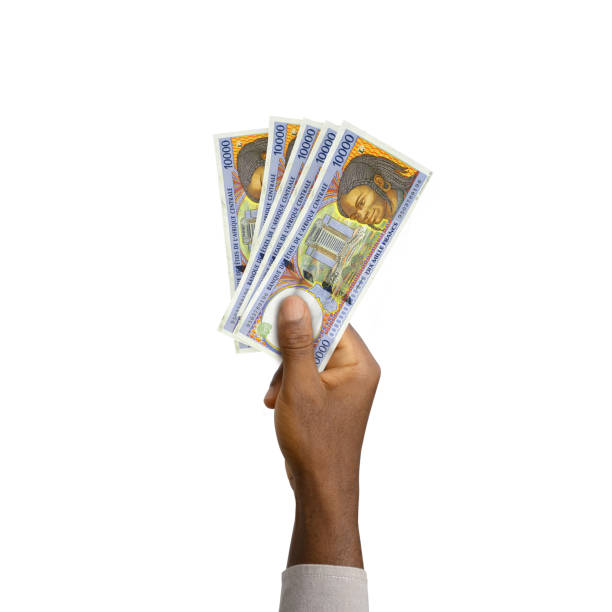 istock Black Hand holding 3D rendered Central African CFA franc notes isolated on white background 1372665940