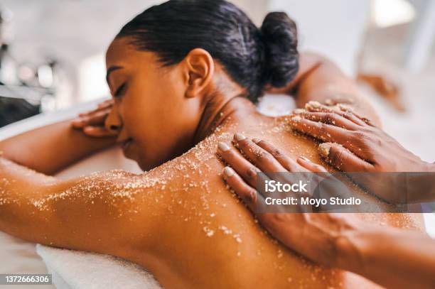 Shot Of An Attractive Young Woman Getting An Exfoliating Massage At A Spa Stock Photo - Download Image Now