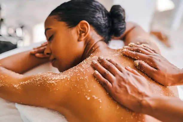 Photo of Shot of an attractive young woman getting an exfoliating massage at a spa