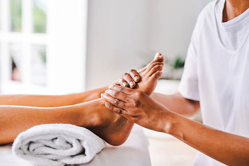 Woman applying hydrating, moisturizing cream. Foot and skin care. Heel protection and hydration