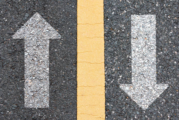 istock up arrow and down arrow on asphalt road 1372668078