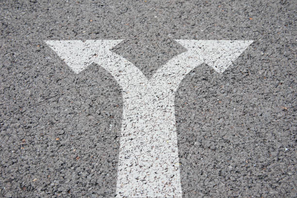 istock arrows separated on the road 1372668101