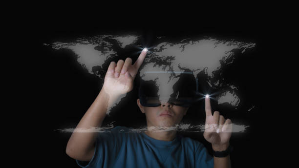 istock Studio portrait man wearing VR Headset touching world map against on black background. Glasses of virtual reality and exploring the metaverse. Technology, gaming, entertainment concept. 1372672036