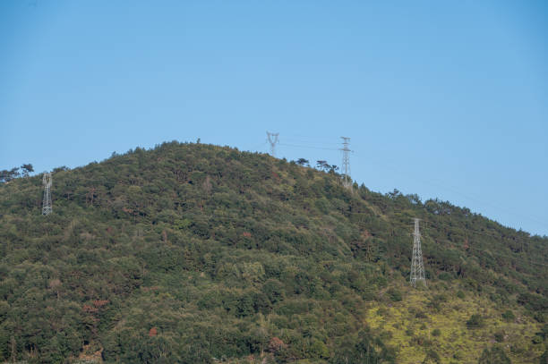 istock Power transmission equipment on the mountain under the blue sky 1372674943