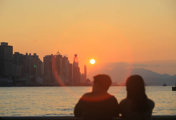 istock the silhouette young couple , watching the sunset 1372677209