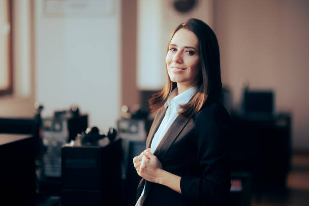 confident business woman standing in the office - lawyer young adult suit expressing positivity imagens e fotografias de stock