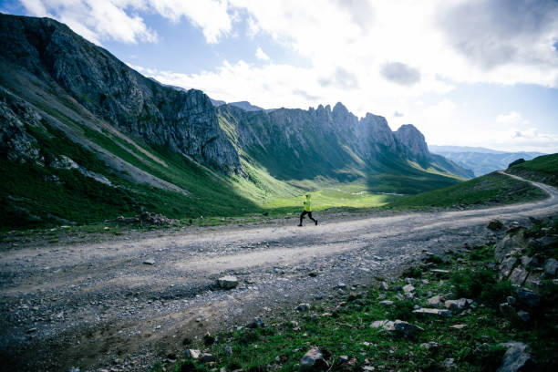 istock Woman trail runner running on mountain top 1372689284