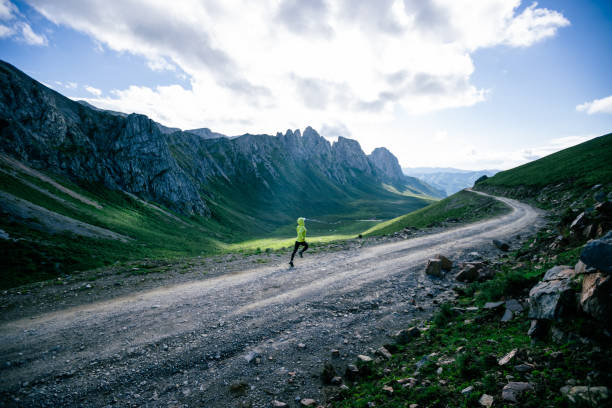 istock Woman trail runner running on mountain top 1372689404