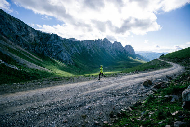 istock Woman trail runner running on mountain top 1372689422