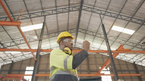 istock Specialist industrial engineer or technician have leadership, wear personal protective equipment, walking and use tablet inspect raw material and inventory in production line at manufacturing factory. 1372690369