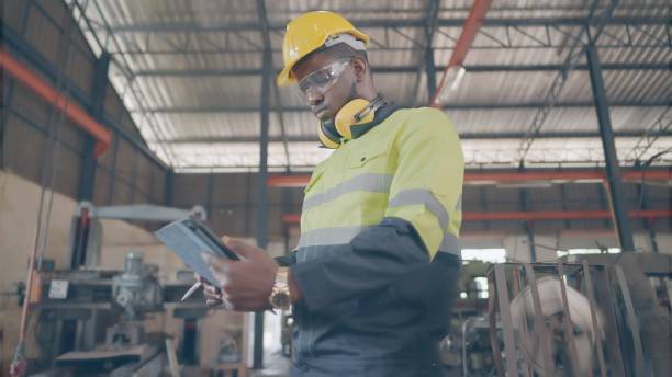 istock Expert industrial engineer or technician have leadership, wear personal protective equipment, standing and use tablet inspect raw material and process work in production line at manufacturing factory. 1372690384