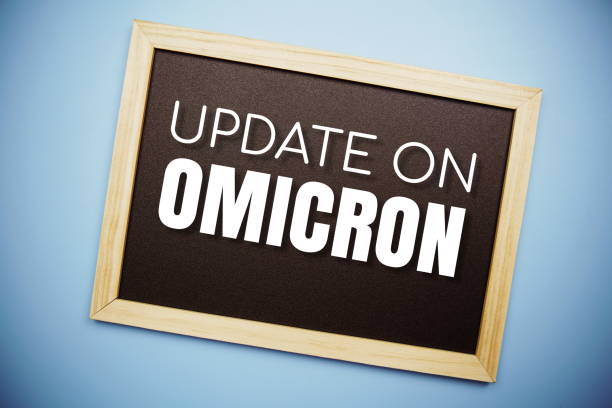 istock Update on OMICRON text on blackboard flat lay on blue background 1372690725