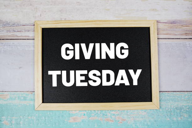 istock Giving Tuesday text on blackboard flat lay on wooden background 1372690817